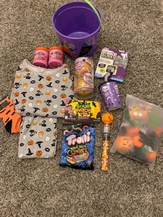 the contents of a child's halloween snack box are laid out on the floor