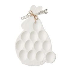 a white ceramic egg shaped like a bunny