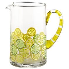 a glass pitcher filled with lemons and lime slices