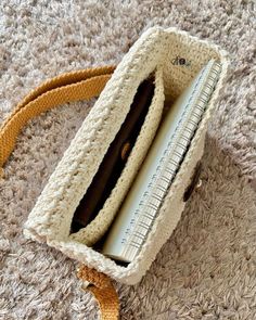 a crocheted purse sitting on top of a carpet