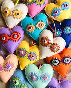 several heart shaped ornaments with eyeballs and eyes on them, all in different colors