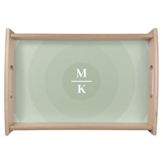 a wooden tray with the letter k in white letters on it and a circular design