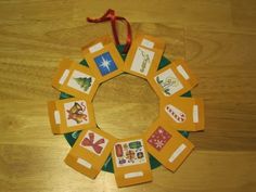 an ornament made out of small cards on a wooden table