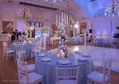 the tables are decorated with purple sashes and white linens for an elegant wedding