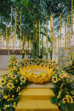 yellow flowers and greenery decorate an outdoor ceremony