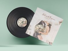 an album with a wedding photo on it next to a vinyl record that reads, always at the same time