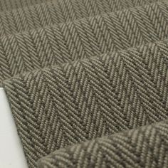 a close up view of the fabric on a tablecloth with herringbones in grey and white