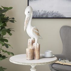 a white bird statue sitting on top of a table