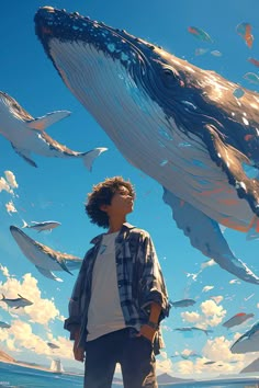 a man standing on top of a beach next to a giant blue whale in the sky