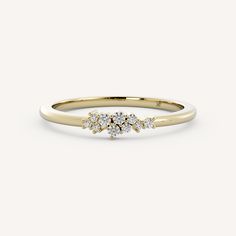 a yellow gold ring with three diamonds on it