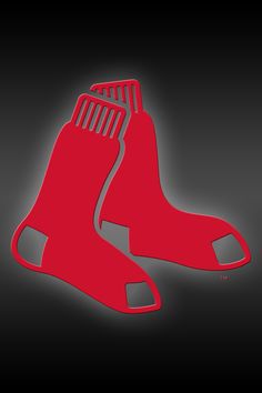 a pair of red baseball socks sitting on top of a black floor next to each other