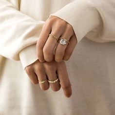 a woman's hand with two rings on it