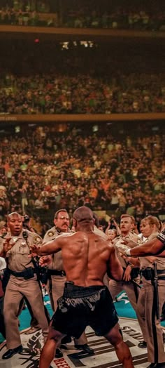 a group of men standing on top of a wrestling ring