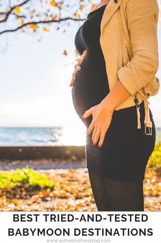 a pregnant woman standing in front of a tree with the caption best tried and tested babymoon destinations