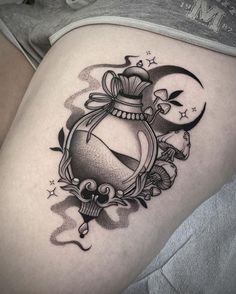 a woman's thigh with a tattoo design on it, and an image of a lantern