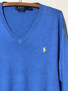 Vintage polo Ralph Lauren blue V-neck sweater. Size large. Made in China. 100% Pima cotton. Blue Casual Polo Sweater With Polo Collar, Blue Casual Polo Sweater, Blue Cotton V-neck Sweater For Winter, Casual Blue Cotton V-neck Sweater, Classic Cotton V-neck Polo Sweater, Casual V-neck Polo Sweater For Winter, Blue Classic Sweater With Ribbed Collar, Classic Blue Sweater With Ribbed Collar, Casual Cotton V-neck Polo Sweater