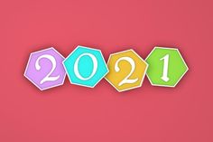 the year 2011 is spelled out with colorful paper cut outs on a pink background, which reads 2012