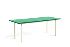 a green table sitting on top of a white floor