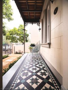 a black and white checkered floor next to a building