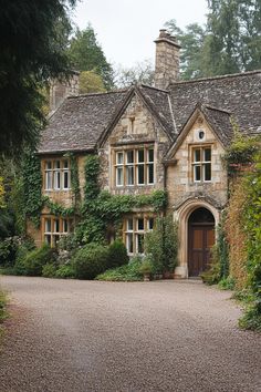 Charming stone house with ivy and an arched wooden door. Explore the quirky charm, secret staircases, and unintentional labyrinths of British country houses, where historical oddities meet modern mishaps in the most delightful way.