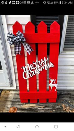 a red christmas sled with the words merry christmas on it and a bow hanging from the front door