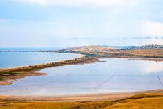 Seascape. The sea is next to the lake, separated by a narrow isthmus from the road stock images Water Nature, The Road, The Sea, Stock Images, Lake, Road