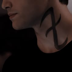 a man with a cross tattoo on his neck