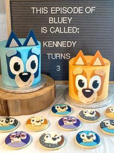 two decorated cupcakes sitting on top of a table