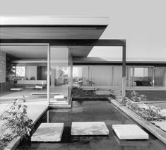 a black and white photo of a modern house