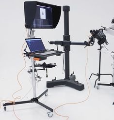 a laptop computer sitting on top of a desk next to other electronic devices and equipment