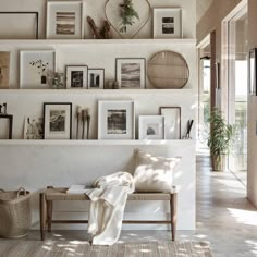 a living room filled with furniture and pictures on the wall