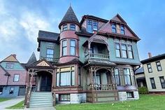 an old victorian style house with many windows