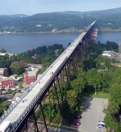 an aerial view of a train crossing over a bridge