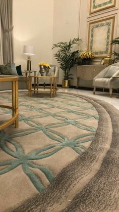 a living room filled with furniture and a rug on top of a hard wood floor