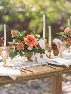 the table is set with candles, flowers and napkins for dinner guests to enjoy