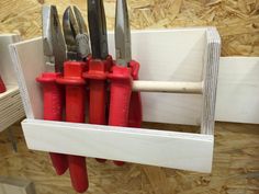 there are many red and white knives in the holder