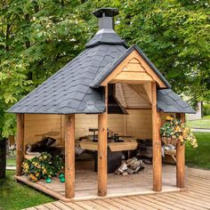 a wooden gazebo sitting on top of a wooden deck