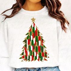 a woman wearing a white shirt with a green and red christmas tree on the front