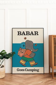 an elephant is carrying a backpack on its back while standing in front of a poster