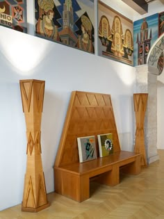 some wooden benches and pictures on the wall