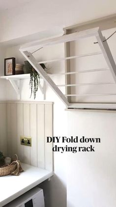 a white shelf with some plants on it and the words diy fold down driving rack