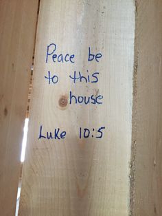 a piece of wood with the words peace be to this house luke 10 5 written on it