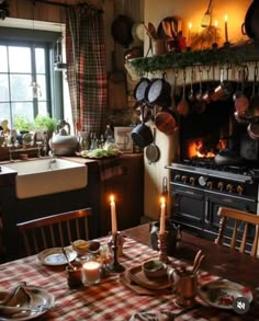 an old fashioned kitchen with candles lit on the table