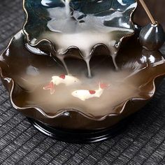 a black and brown bowl sitting on top of a table