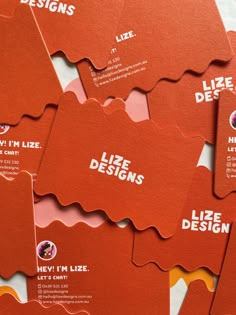 six red business cards with the words life designs printed on them, all in different shapes and sizes