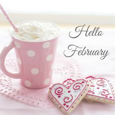 two heart shaped cookies and a cup of coffee on a pink doily with the words happy valentine's day