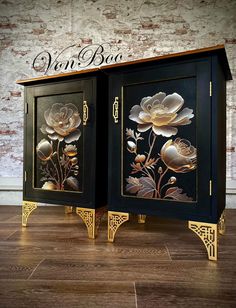 a black cabinet with gold flowers painted on the front and sides, sitting on a wooden floor