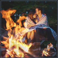 a couple sitting next to each other in front of a fire