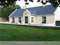 a white house with blue roof and windows