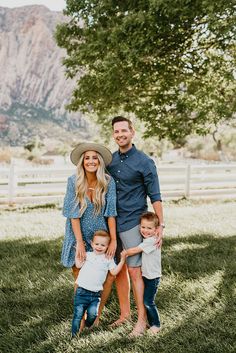 a family posing for a photo in front of a mountain